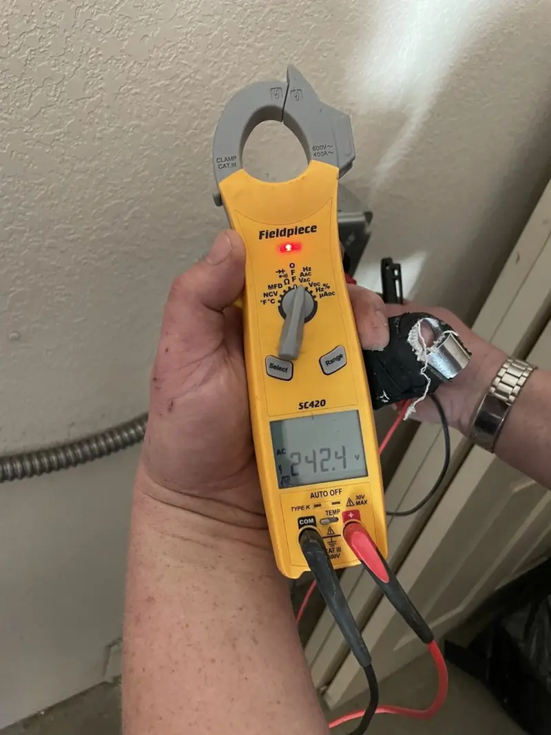 Voltage testing with clamp meter during Ceiling Fan Installation in Belfast